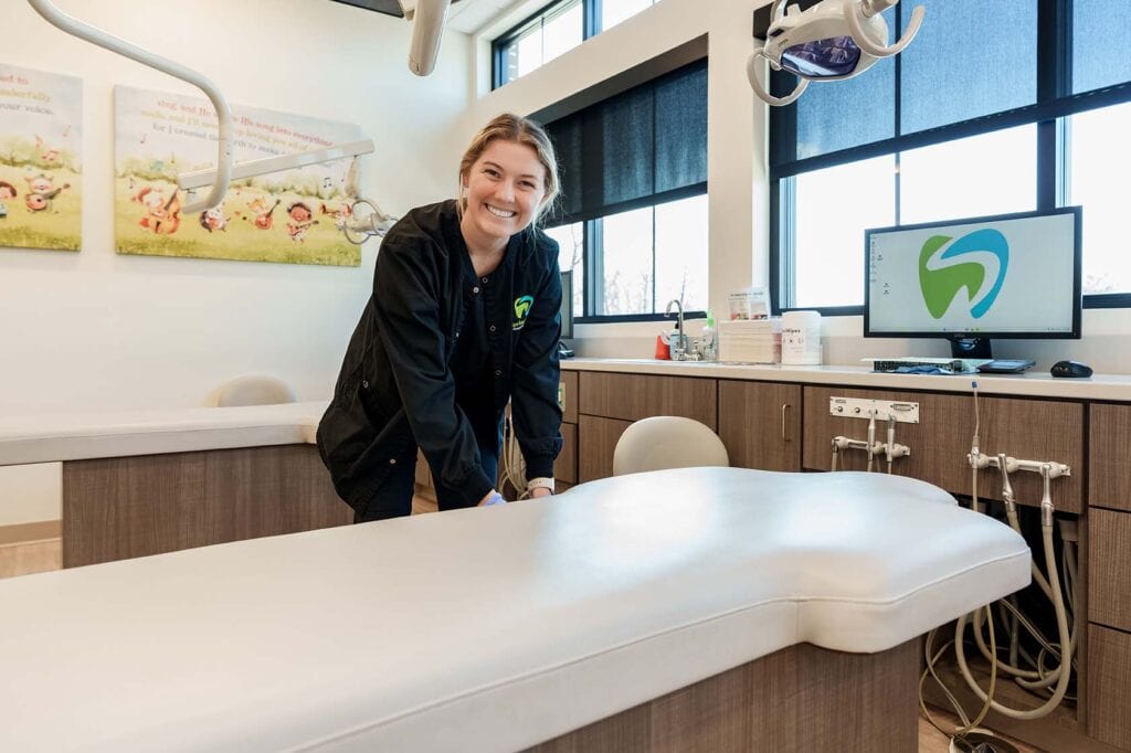 Dental assistant setting up chair