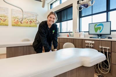 Dental assistant setting up chair