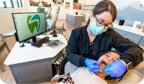 Little girl getting her teeth flossed at the dentist