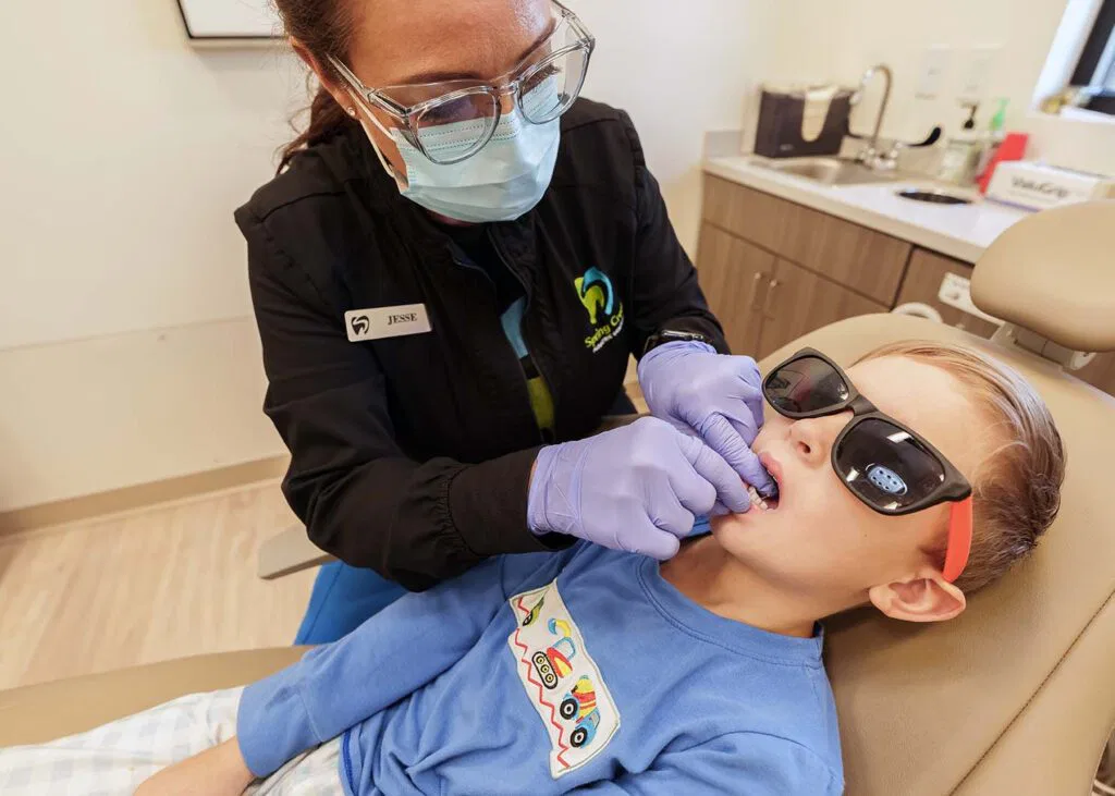Young boy getting teeth cleaned