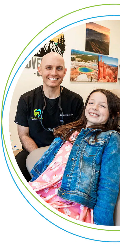 A smiling girl patient gets dental treatment at Spring Creek Pediatric Dentistry by Dr. Kennedy.