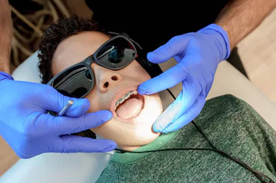 Young boy getting teeth checked by dentist