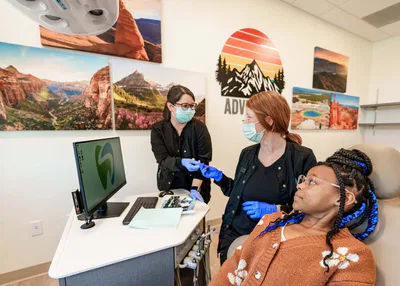 Young girl at dentist in chair with dental assistants